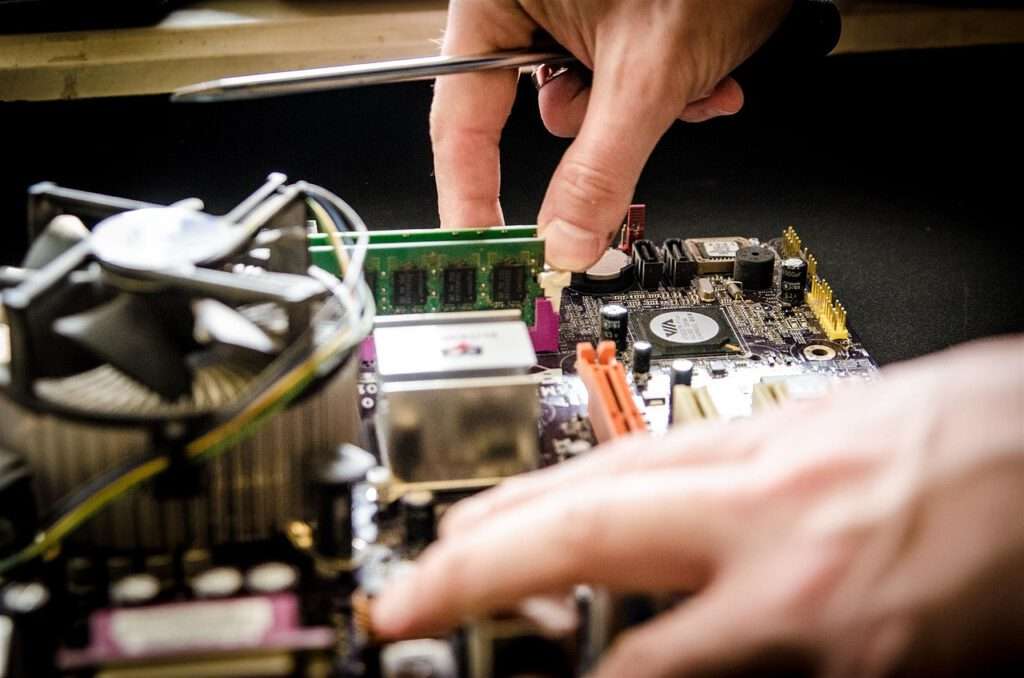 someone working on taking apart a computer