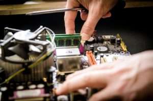 someone working on taking apart a computer
